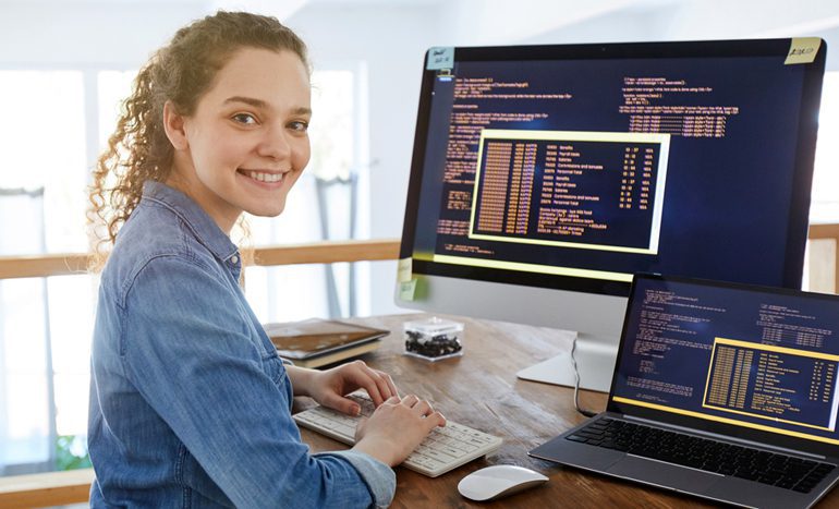 Smiling female IT developer at workplace
