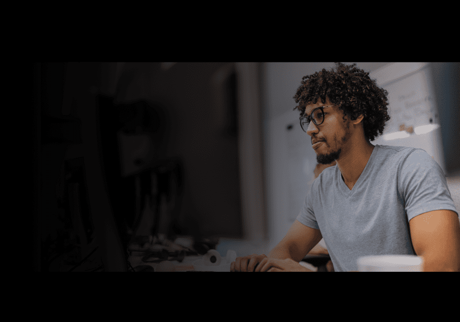 Man with curly hair and glasses