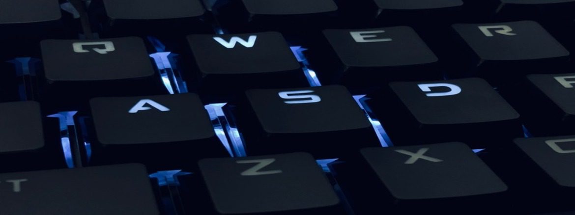 A close-up of a keyboard with the keys 'W', 'A', 'S' and 'D' illuminated.