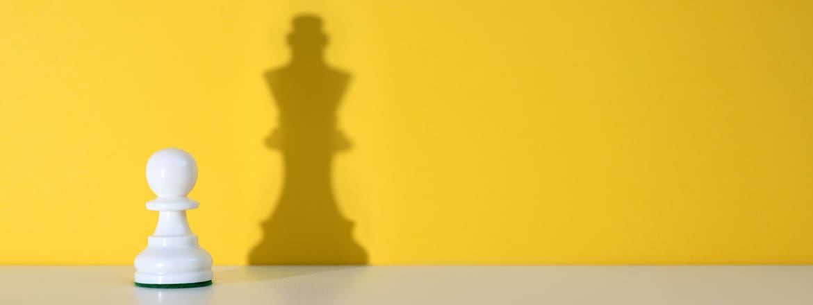 Featured image for article titled "Why Every Company Should have a Tech Leadership Development Plan" showing a chess pawn with a shadow of a chess king.