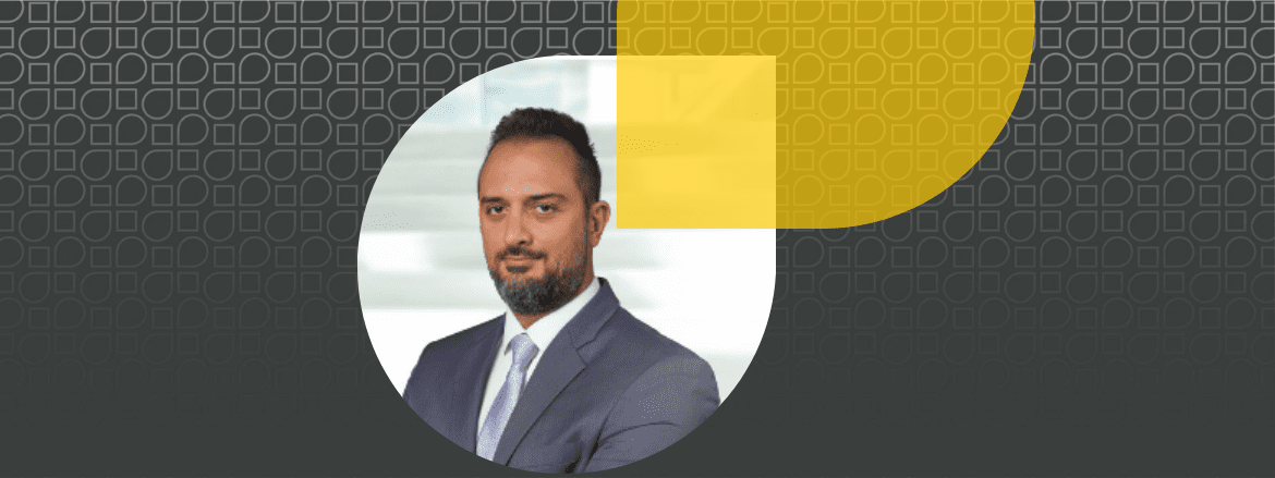 Featured image for article about elev8's employee, Fadi's story showing Fadi in a circle shape with a grey and yellow background.